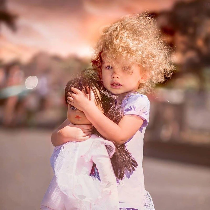20. Protecting her doll
